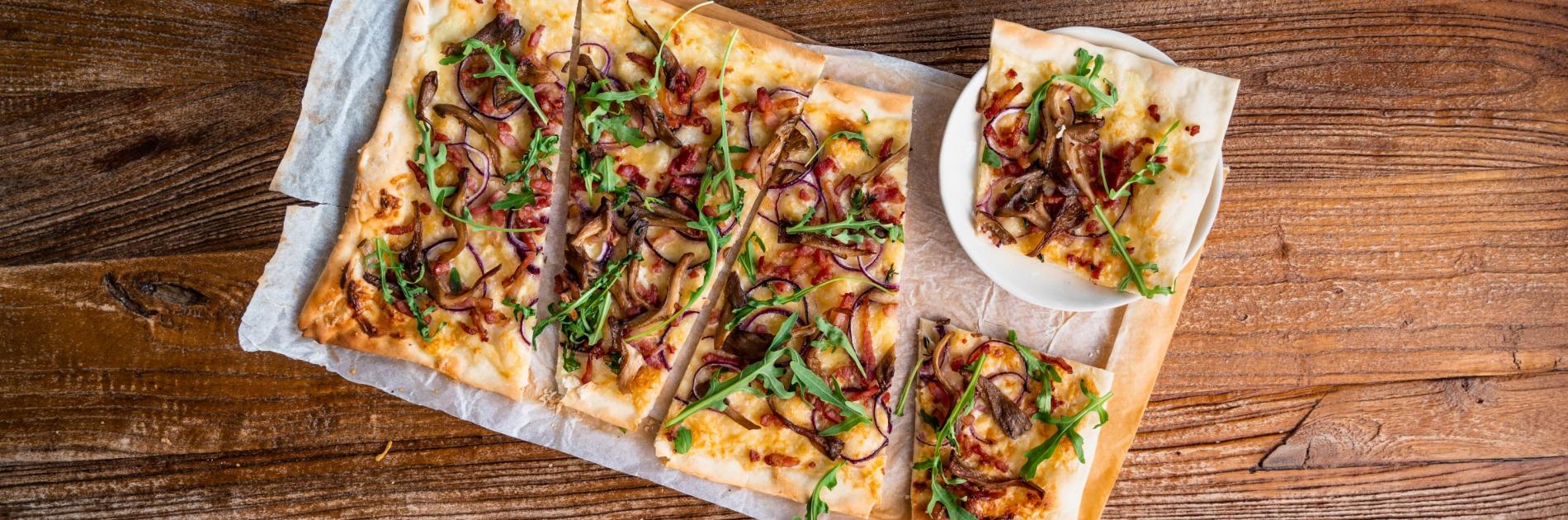 Flammkuchen with bacon, onion, and oyster mushrooms